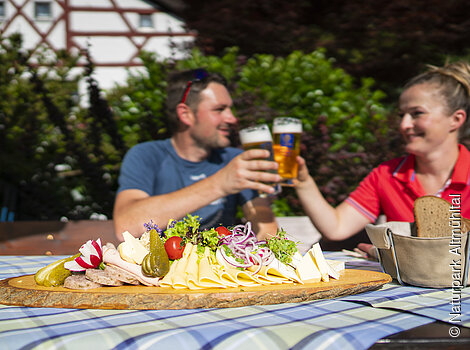 Pärchen mit bayerischer Brotzeit im Biergarten "Zum blauen Hecht" Kipfenberg